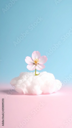 a pink flower sitting on top of a cloud