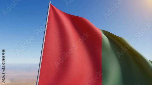 Burkina Faso Flag Waving Majestically Against Bright Blue Sky