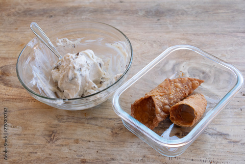 Sicilian cannoli cream preparation on wood