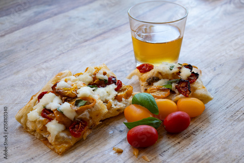 Italian focaccia pizza with glass of white wine