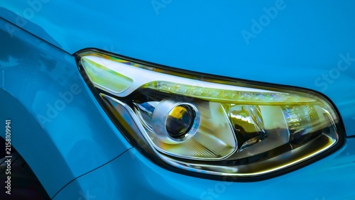 Modern car headlight design with blue bodywork for vehicle engineering