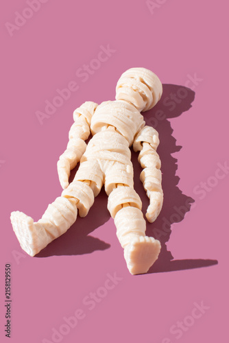 Принти на полотні White mummy or zombie lying down on a purple background