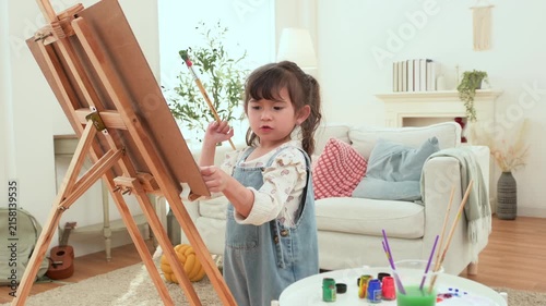 Child Enjoys Painting at Home While Expressing Creativity and Learning in a Bright Room
