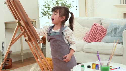 Child Enjoys Painting at Home While Expressing Creativity and Learning in a Bright Room