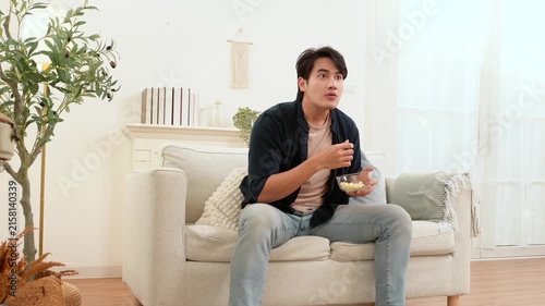 Man Celebrates While Watching Football at Home Showing Excitement and Joy During the Game