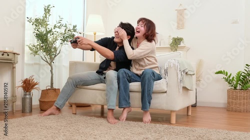 Couple Plays Video Game Together in Living Room on a Cozy Afternoon at Home