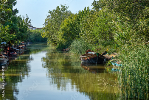 Traditional colourful boats from La Albufera Natural Park, in Valencia, Spain, moored in the harbour
