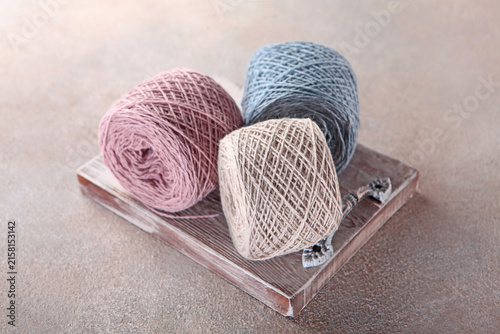Obraz na płótnie Skeins of pastel-colored cotton yarn on a wooden stand