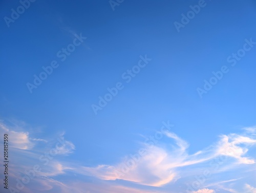 Clear blue sky with soft wispy clouds in the afternoon