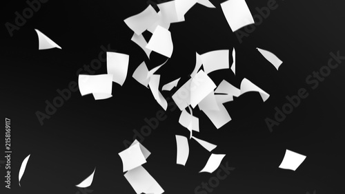 White paper fragments floating in mid-air against a dark background