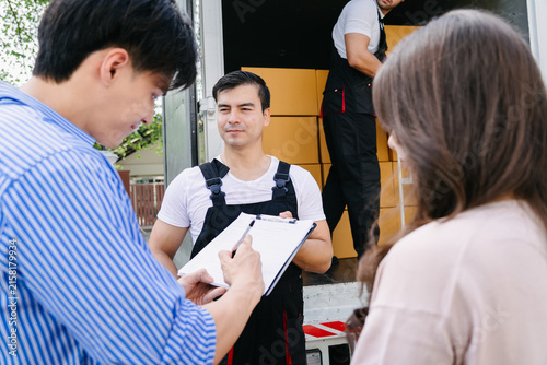 Moving Service Customer Signing Delivery Document for Home Relocation