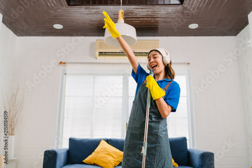 Young Woman Cleaning Home Happily Enjoying Domestic Chores