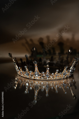 Obraz na płótnie Golden Royal Crown with Crystal Details and Reflection on Brown Background