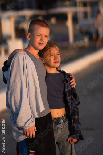 Children looking into the distance. Brother and sister hug and admire the sunset. High quality photo