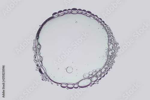 Macro cosmetic gel texture background. Transparent facial serum fluid drop with oxygen bubbles circle shape isolated on white background. Skincare moisturizer lotion sample, clinical wellness concept.