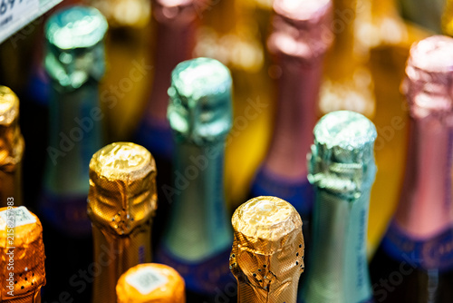 Obraz na plátně Colorful champagne bottle collection with metallic foil tops