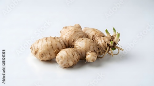Fresh raw ginger root rhizome and a sliced piece, isolated on a clean white background. Perfect for culinary, spice, and herbal health project.