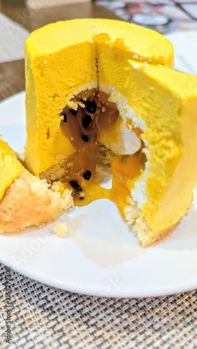 Obraz na plátne Delicate mango soufflé with a coconut cream core, fresh whipped cream, and a tangy passion fruit filling, all resting on a coconut flake crust