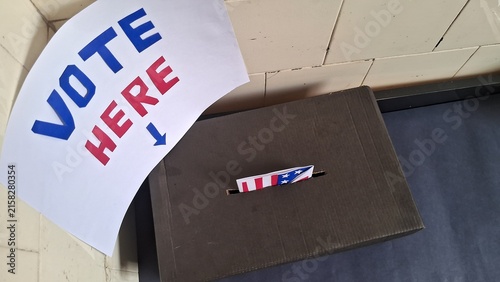 Bild auf Leinwand Patriotic ballot being inserted into a black cardboard election drop box