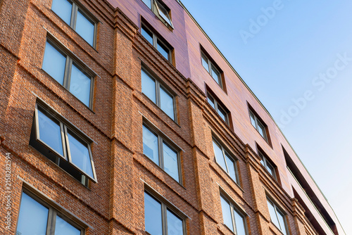 Modern brick architecture and residential building under clear blue sky