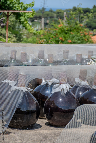 Konstfotografi Sunbaked sweet Banyuls fortified wine in traditional demijohns bonbonnes glass j
