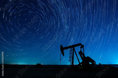 Fotografie Star trails over Texas oil field