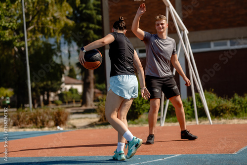 Photography Young basketball players practice dribbling skills on an outdoor court in summer