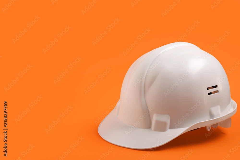 Fototapeta premium White hardhat on orange background