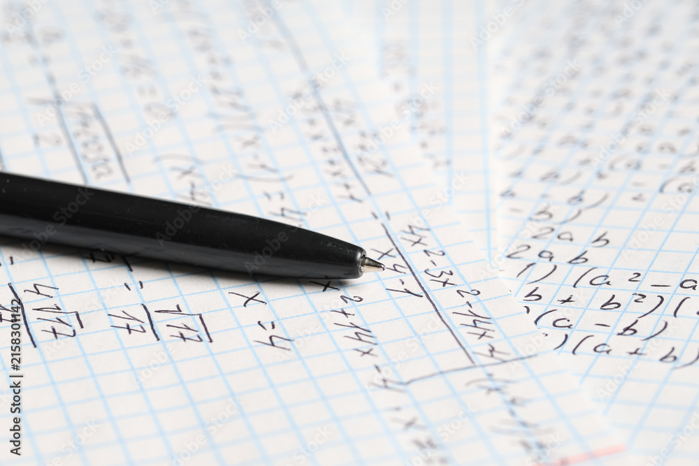 Fototapeta premium Copybook with handwritten maths formulas and pen as background, closeup