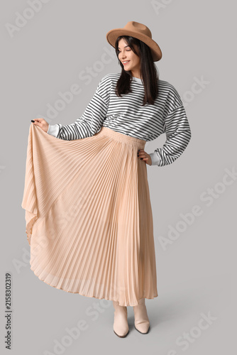 Young Asian woman in beige ...