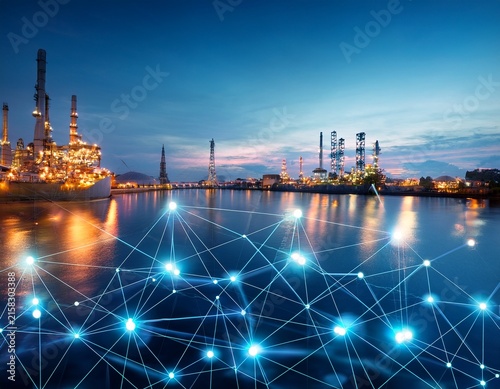 network connection concept with glowing nodes floating on water surface at industrial facility at night