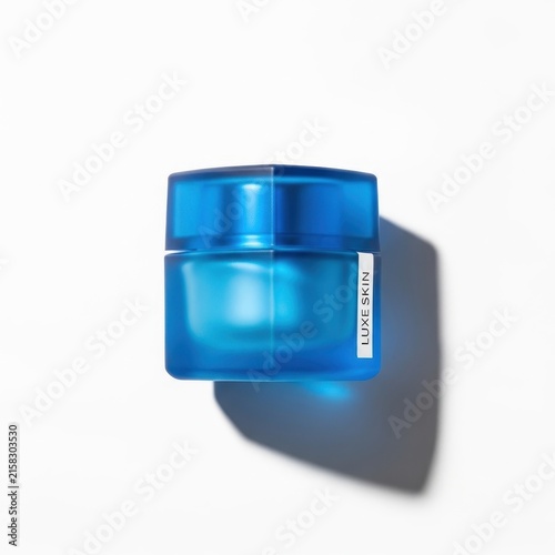 Blue Skincare Jar with Reflective Surface and Shadow.