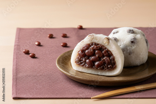 Mame daifuku wagashi with whole red beans and azuki filling, cut open