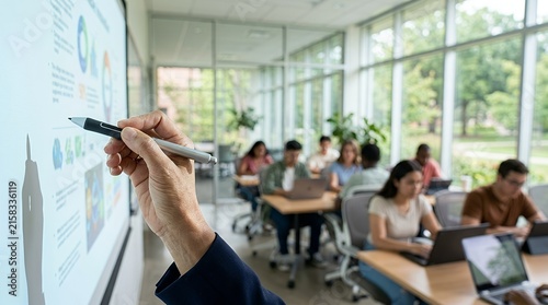 A professional instructor pointing at a digital whiteboard during a collaborative business workshop or training session.