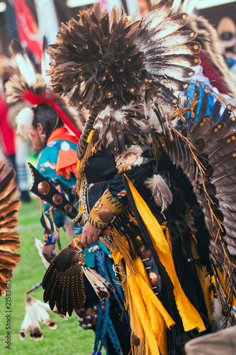 Canvas Print Vibrant Native American powwow regalia with colorful feathers, intricate beadwork, and traditional dance outfits at an outdoor cultural celebration