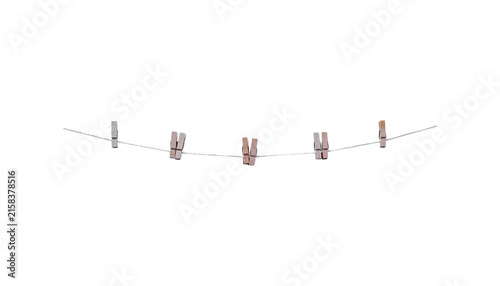 Foto Brown wood clothes pins hanging on white rope isolated on white background , cli