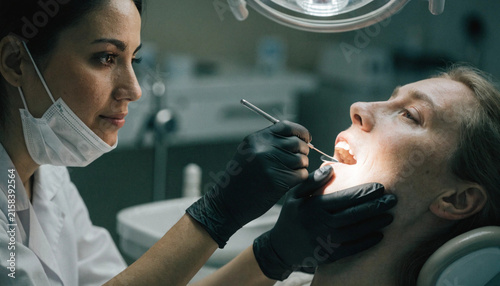 Dentist Examining Patient's Teeth During Routine Checkup
