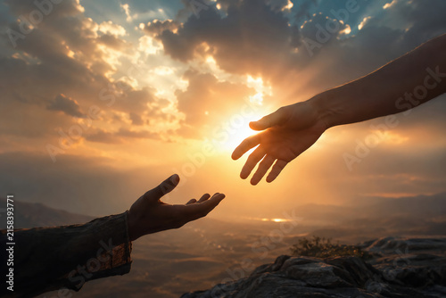god hand reaching out to help person at sunset