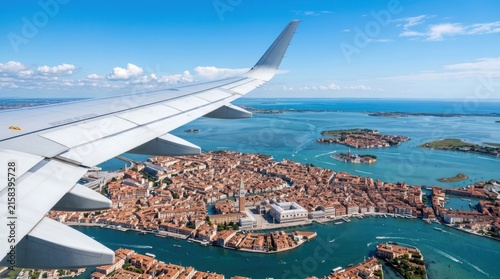 Aerial View of Venice from Airplane Window with Wing in Foreground.