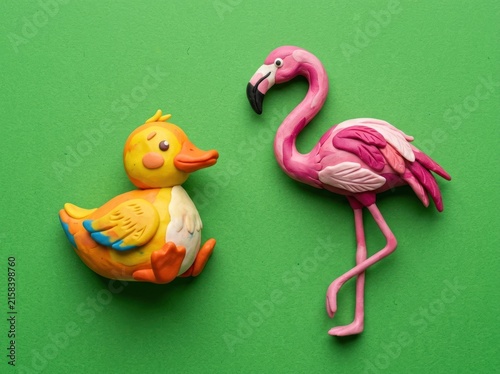 Charming Handmade Clay Duck and Flamingo Figures on Green Background.