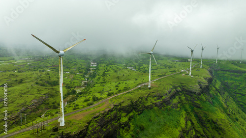 Quadro su tela Wind farm surrounded by green hills
Wind energy infrastructure aerial view, Indi