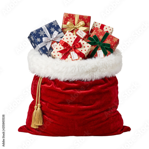 Red velvet Santa sack filled with colorful Christmas gifts
