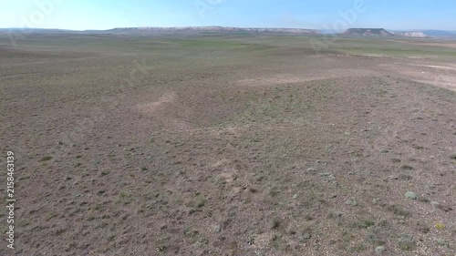 Aerial Turkmenistan hills dry plains barren ridges treeless grassland highland weather detail.