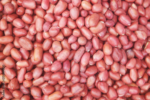 Many raw peanuts as background	