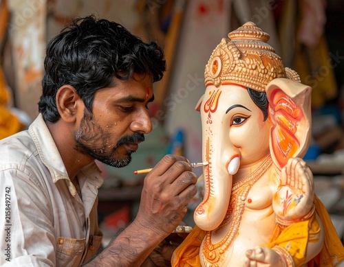 Close-up of young Indian artist painting a handmade Ganpati idol with a brush and natural colors, highlighting traditional craftsmanship, eco-friendly art, creativity, and Ganesh Chaturthi.