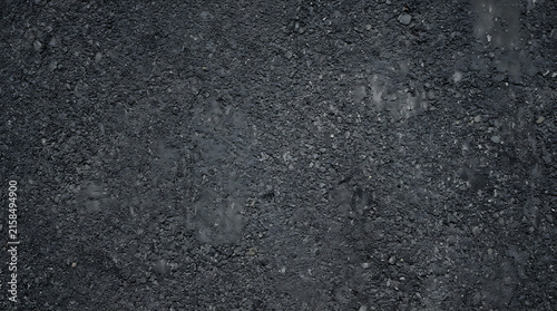 Rough Dark Grey Asphalt Road Surface Texture with Crushed Stone Aggregate for Background or Pavement