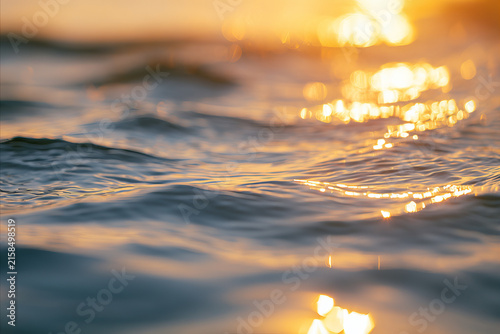 capturing gentle ripples on the surface of water during a golden hour. the su...