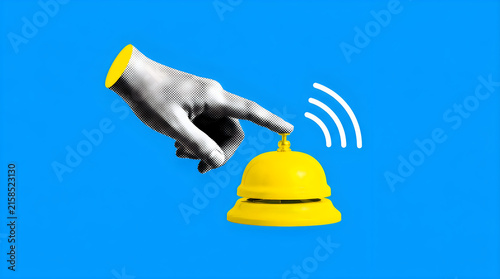 Human hand ringing yellow hotel service bell on vibrant blue background