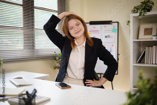 Bild auf Leinwand Young businesswoman easing neck pain after prolonged computer work