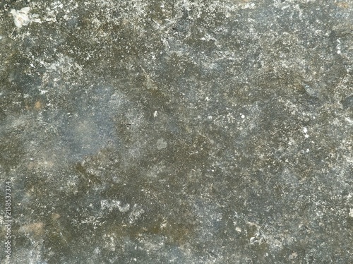 Foto old concrete wall,Weathered stone surface with muted gray, brown, and white tones